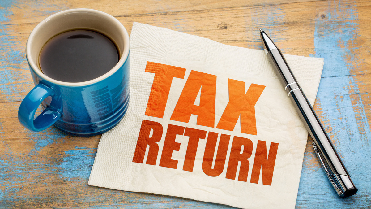 Form 1040-X filing amended return with a cup of coffee