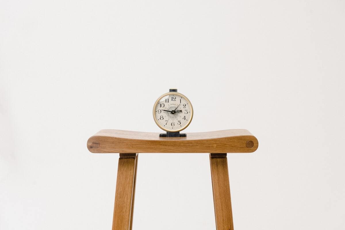 tiny clock on wooden table